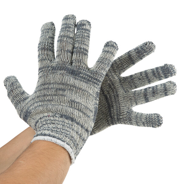 A pair of small hands wearing gray and white Cordova jersey gloves.