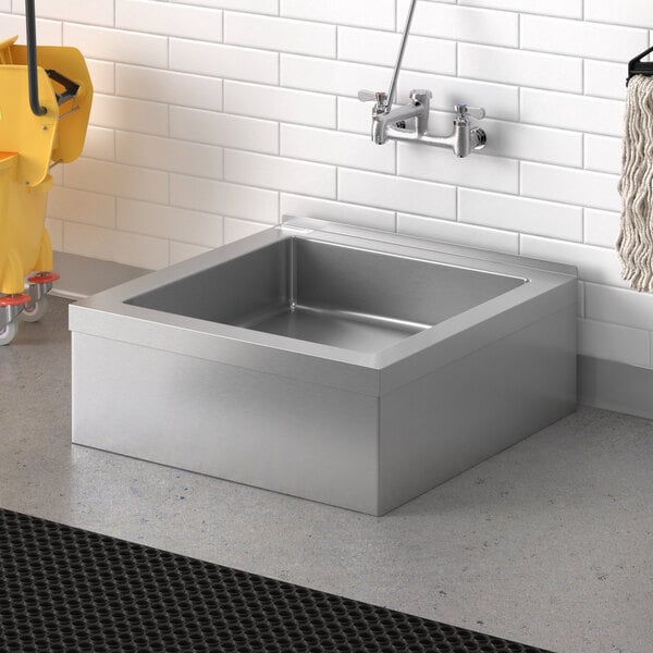 A Steelton stainless steel mop sink in a room.