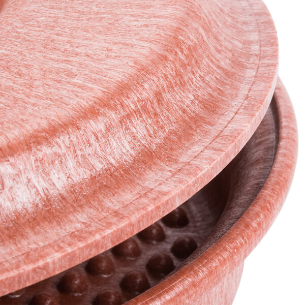 A close up of a plastic container with a lid and holes in it.