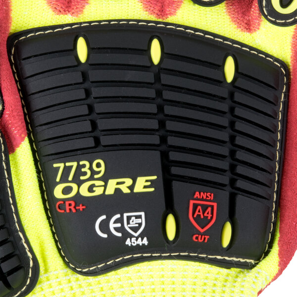 A pair of yellow and black Cordova OGRE-CR+ gloves with red sandy nitrile palm coating and TPR reinforcements.