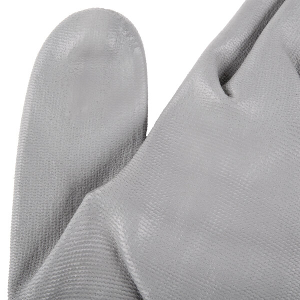 A pair of grey gloves with a grey rubber palm coating.