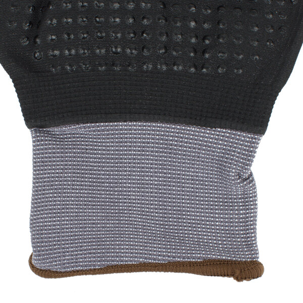 A close up of a black and gray Cordova Conquest Xtreme glove with black foam nitrile and nitrile dots.