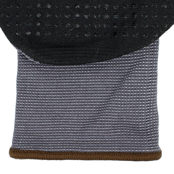 A pair of grey and black Cordova Conquest Plus gloves with black nitrile dots on the palm.