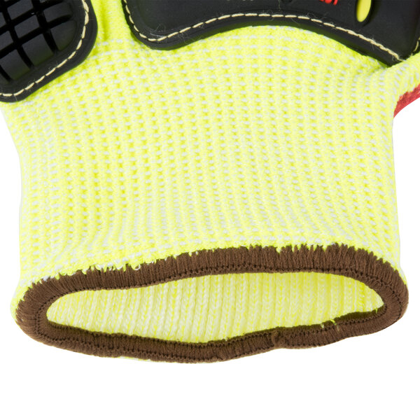 A close up of a yellow Cordova OGRE-CR+ heavy duty work glove with red and black accents.