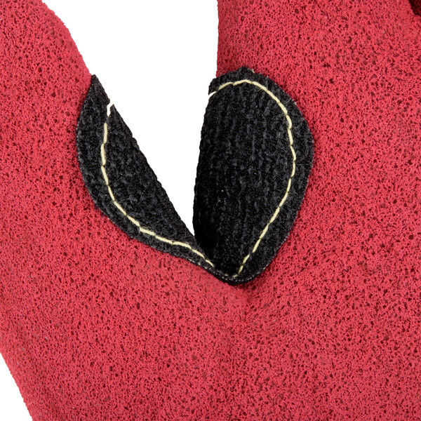 A close up of a small yellow Cordova work glove with red palm coating.