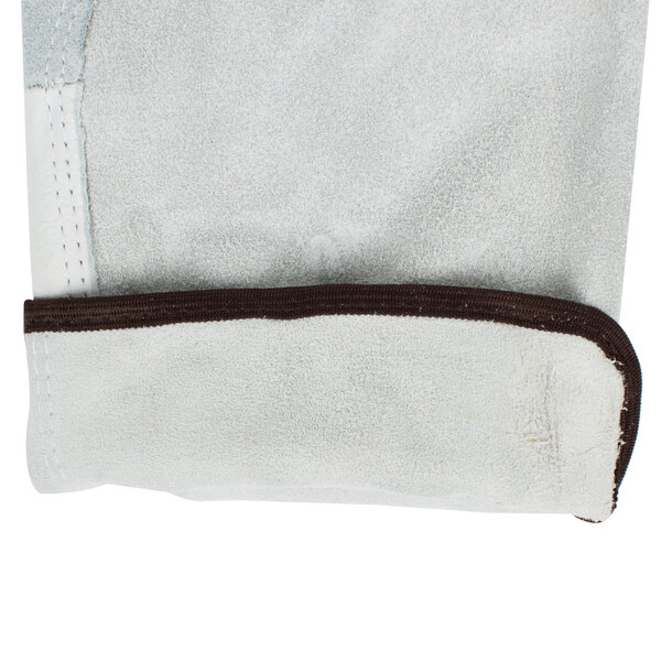 A pair of white Cordova grain leather gloves with brown trim.