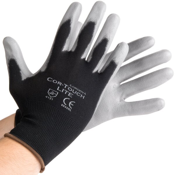 A pair of black gloves with gray on the palms.