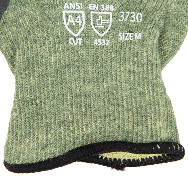 A close up of a pair of green Cordova Cut-Resistant gloves with black foam nitrile coating.