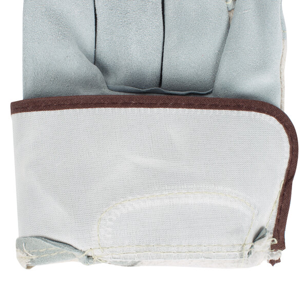 A close up of a Cordova white canvas work glove with a leather palm and rubber cuff.
