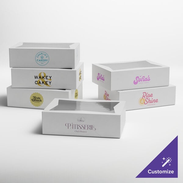 A set of white customizable bakery boxes with clear window tops, each featuring different printed logos and designs.