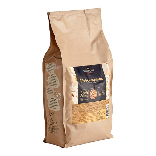 A brown bag of Valrhona Dulcey chocolate pearls with a label on a white background.