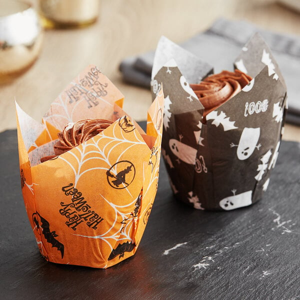 A cupcake in a Baker's Mark Halloween tulip baking cup with a spider web design.