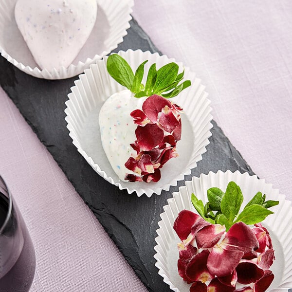 A white strawberry with Sosa red rose petals on top.