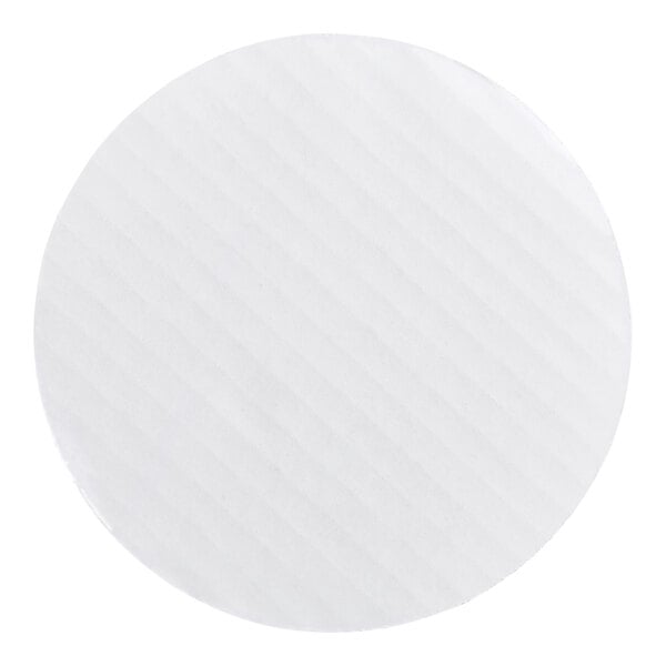 A round, white, corrugated grease-resistant cake circle.