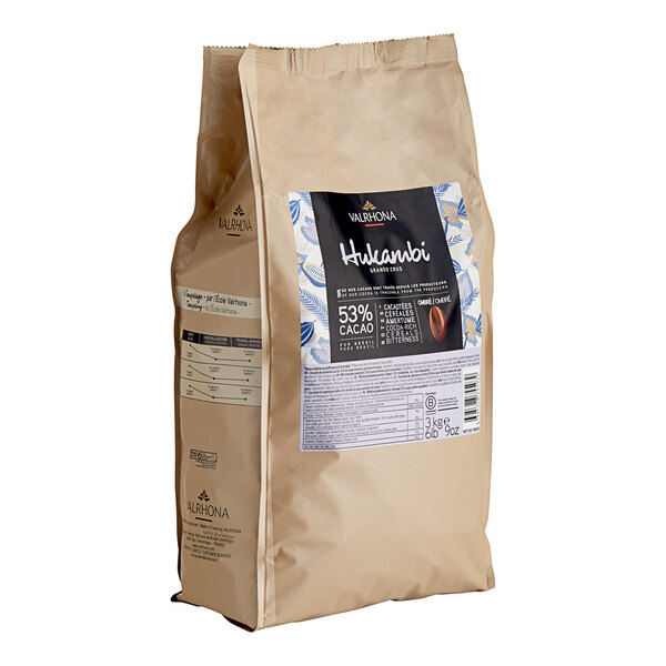 A brown bag of Valrhona Hukambi milk chocolate feves with a label.