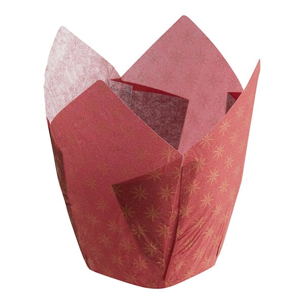 A red paper baking cup with gold designs.