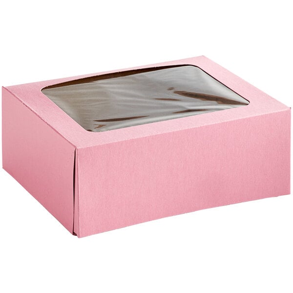 A pink Baker's Mark bakery box with a clear window.