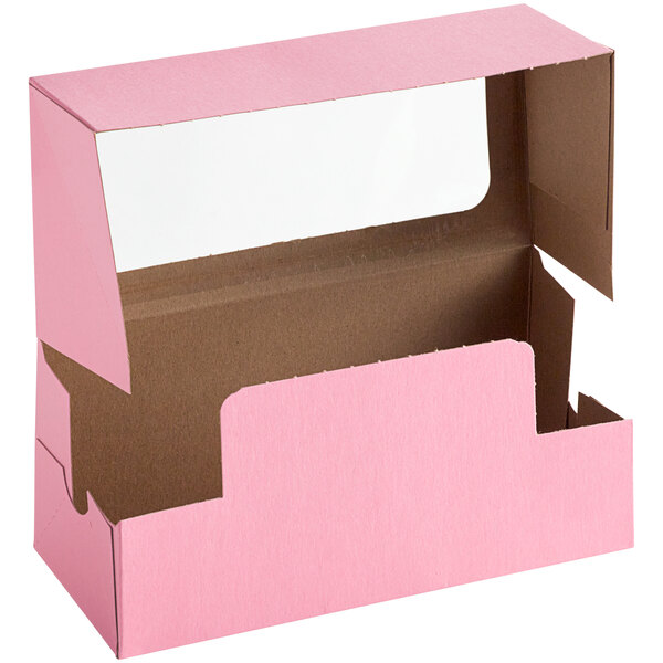 A pink Baker's Mark bakery box with a clear window.
