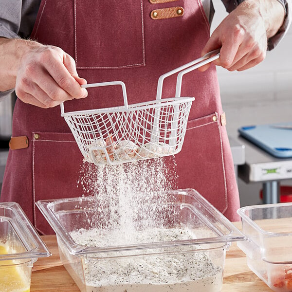 A person pouring flour into a Choice breading basket.