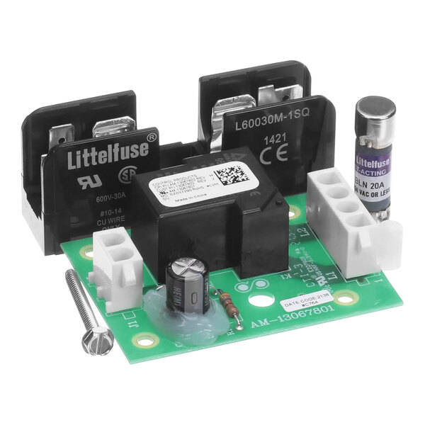 A green circuit board with two black and white electrical components.