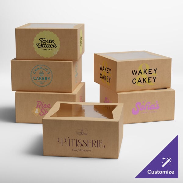 A set of customizable kraft bakery boxes with clear window tops, each featuring different bakery logos and designs.
