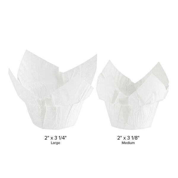 Two white Baker's Mark paper cupcake liners with a measuring guide.