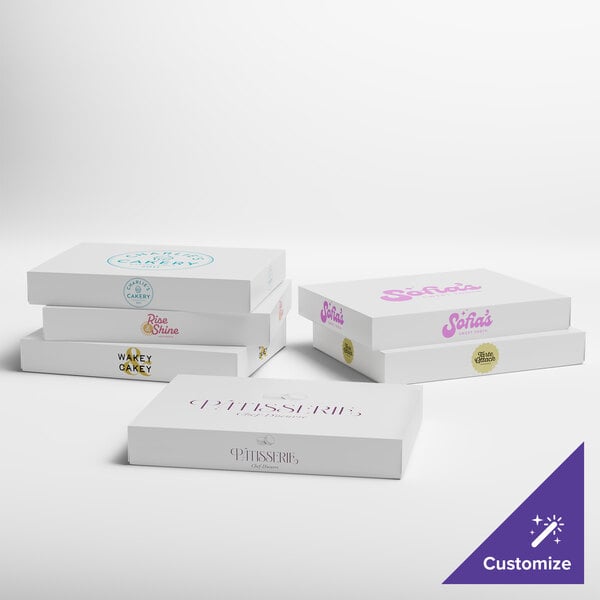 A set of white customizable bakery boxes with various printed logos and designs.