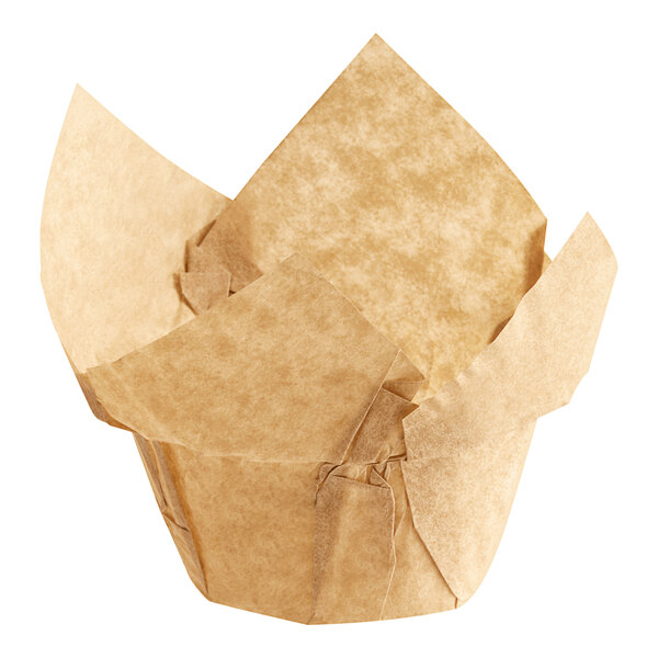 A close-up of a brown paper Baker's Mark muffin wrapper with a folded top.