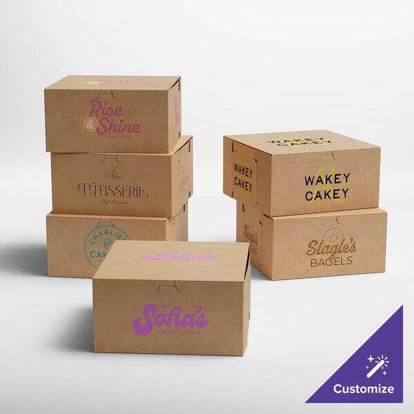 A group of brown Baker's Lane bakery boxes with black and pink text and logos on them.