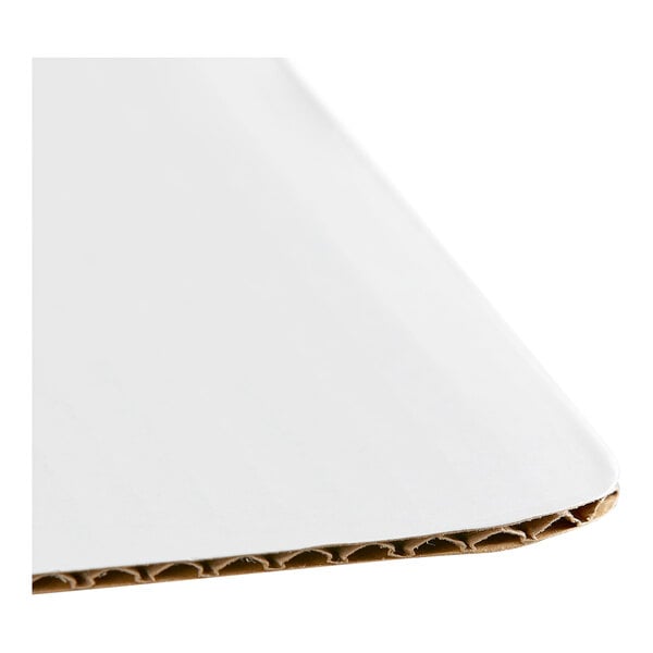 A white corrugated grease-resistant quarter sheet cake pad.