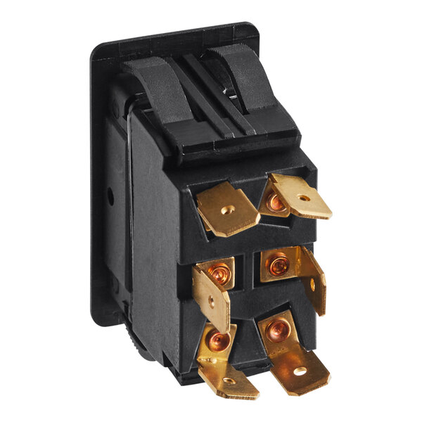 A black electrical switch with gold colored connectors.