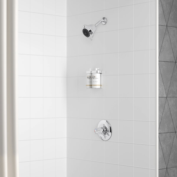 A white shower with a Delta shower head and hand shower on the wall.