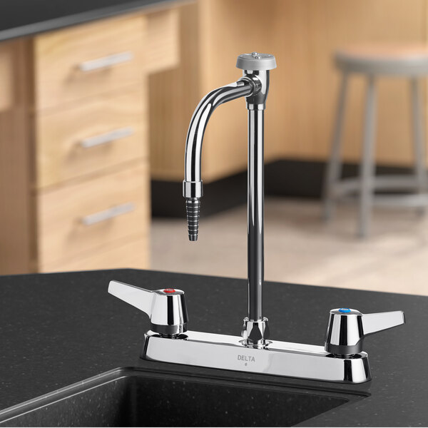 A Delta laboratory faucet with two lever blade handles and a gooseneck spout on a counter.