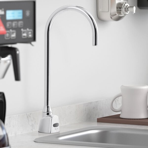 A Delta electronic touchless faucet with a gooseneck spout on a counter.