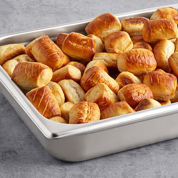 A large metal pan filled with J & J Snack Foods SuperPretzel Bavarian Soft Pretzel Bites.