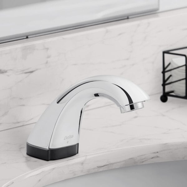 A silver Delta touchless electronic faucet on a counter.