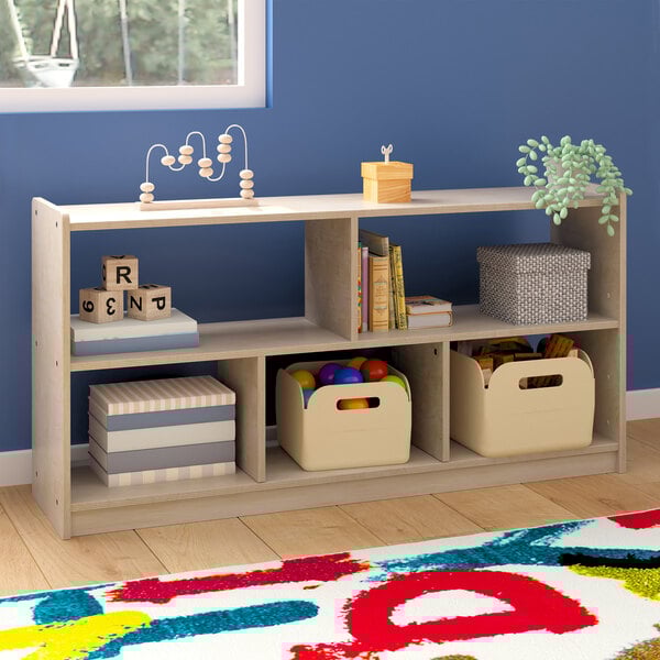 A Flash Furniture wooden open storage unit with toys and boxes on the shelves.