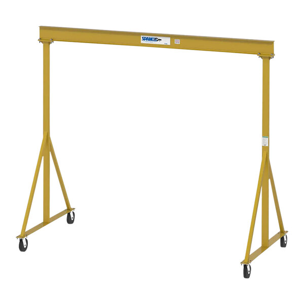 A yellow metal Spanco E-Series gantry crane beam with wheels.