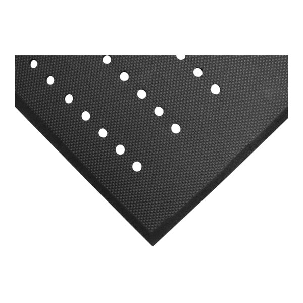 A close-up view of a black textured mat with evenly spaced round drainage holes and a beveled edge.