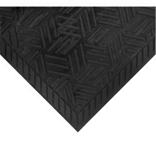 A close-up of a black rubber mat with a geometric textured pattern and a beveled edge.