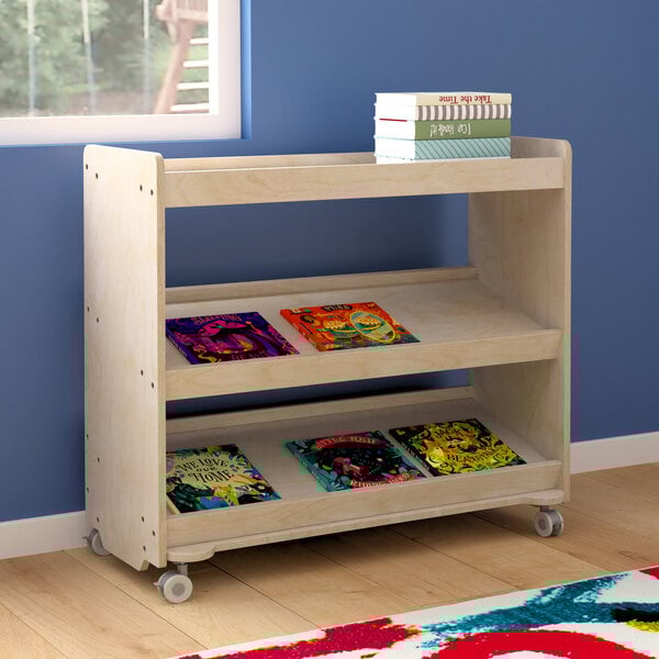 A wooden 3-shelf storage cart with books on it.