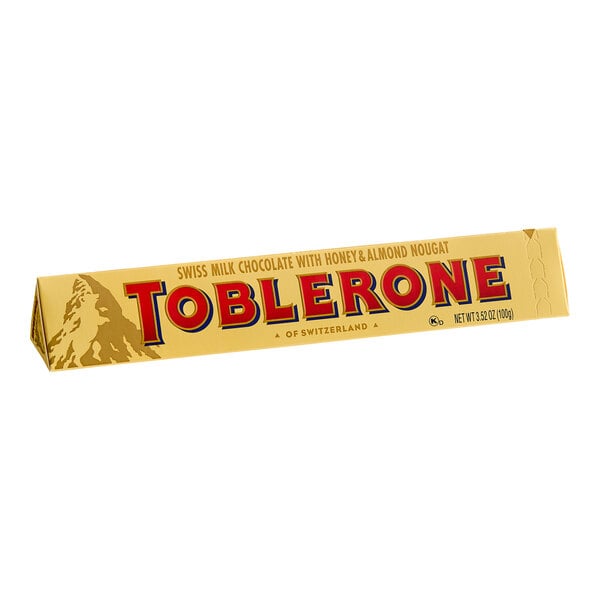 A yellow Toblerone milk chocolate candy bar with red and blue text.