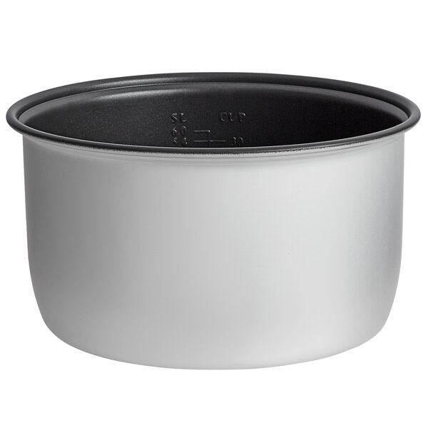 A close-up of a white and black non-stick pot with a lid.