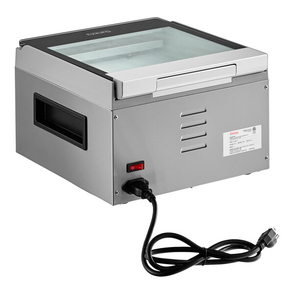 A grey rectangular Galaxy vacuum packaging machine with a glass top.