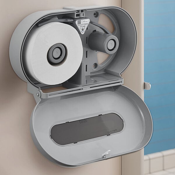 A Lavex VersaHub gray double roll jumbo toilet paper dispenser on a wall.