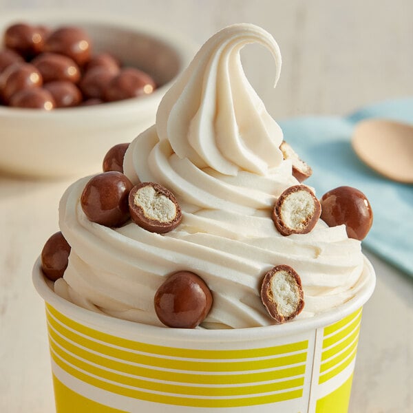 A cup of ice cream with Albanese milk chocolate covered pretzel balls.