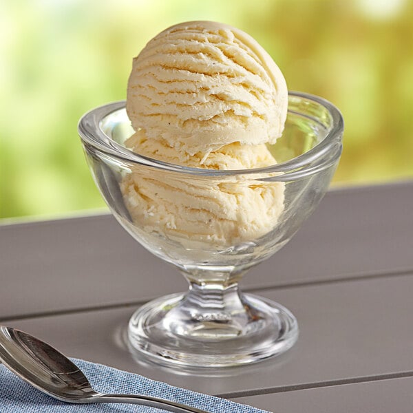 A bowl of I. Rice Cake Batter ice cream with a spoon on the side.