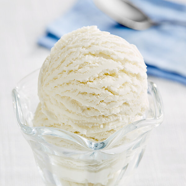 A scoop of I. Rice Key Lime hard serve ice cream in a glass bowl.