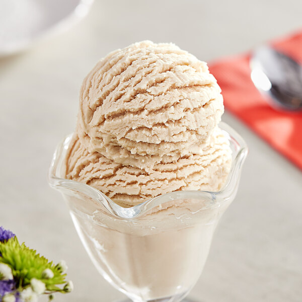 A scoop of I. Rice Bay State Vanilla hard serve ice cream in a glass bowl.