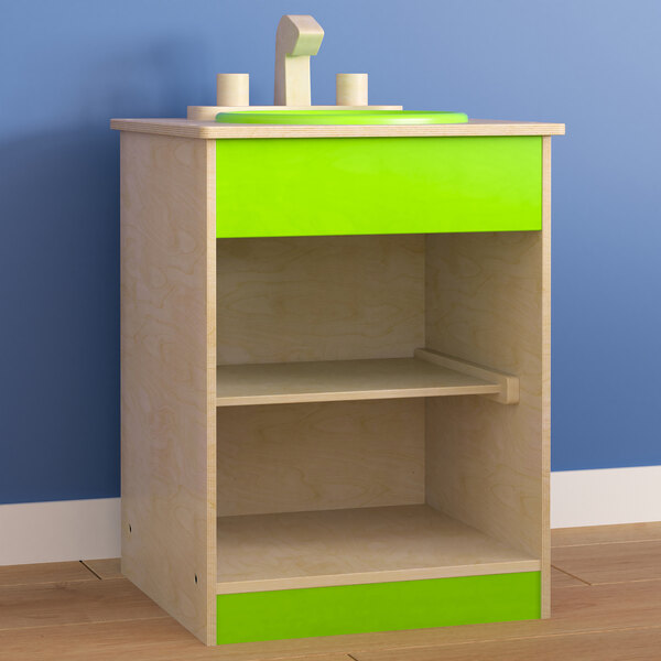 A green and white wooden children's play sink with a shelf.